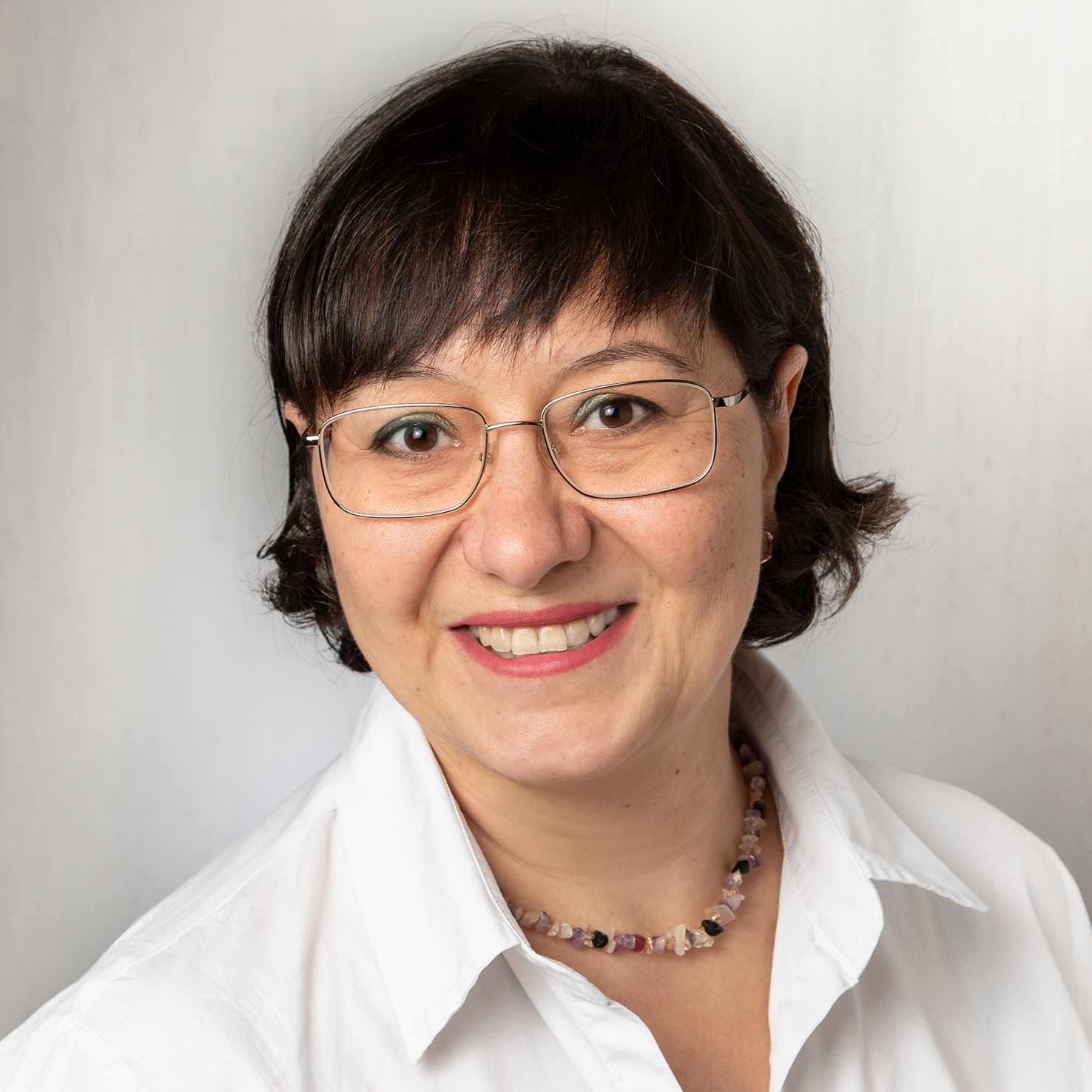 Das Foto zeigt Frau Halyna Waldeyer, Mitarbeiterin der kefb Südwestfalen. Sie hat schwarze, kinnlange Haare, trägt eine Brille und lächelt freundlich in die Kamera.